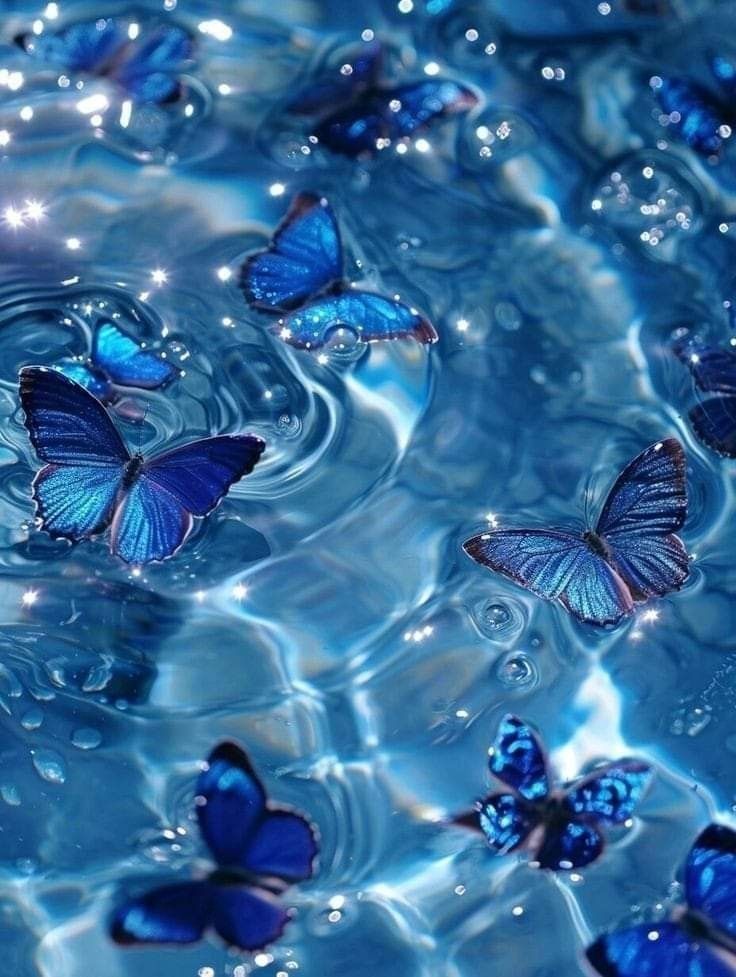 several blue butterflies floating in water with bubbles on the bottom and one flying above them