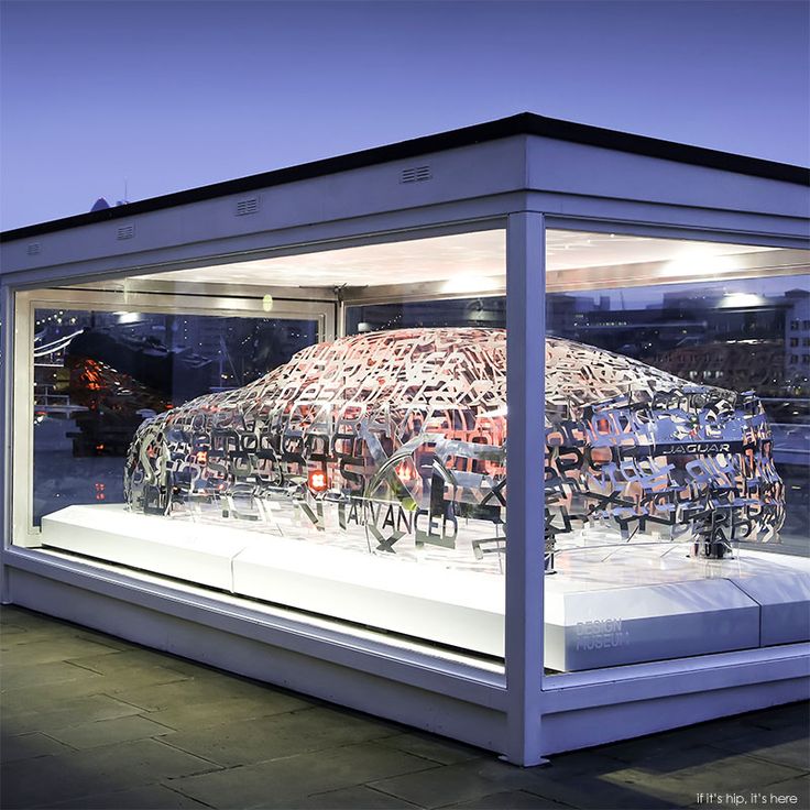 a glass display case filled with lots of different types of items in front of a building