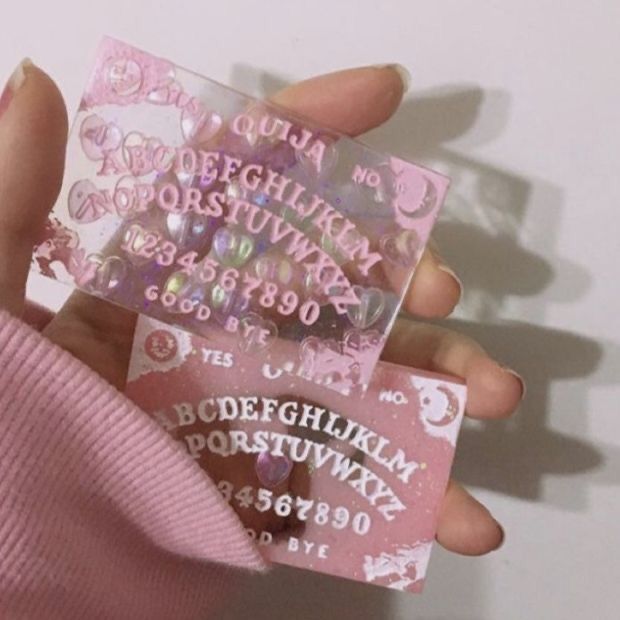 a person holding up some type of pink sticker in their hand with the letters and numbers on it