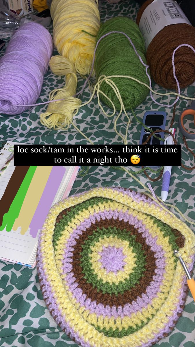 crochet and knitting supplies laid out on a bed with the caption, loc - yarn in the works think it is time to call it a night this