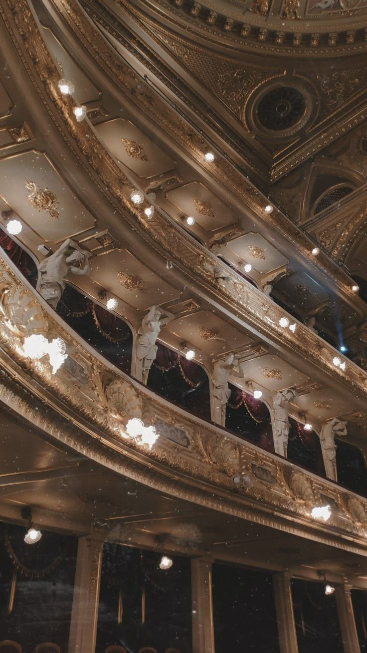 an ornately decorated auditorium with chandeliers and lights