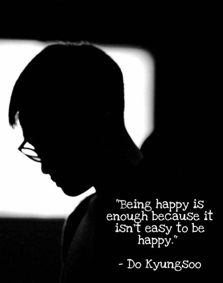 a man with glasses is looking at his cell phone and has a quote about being happy