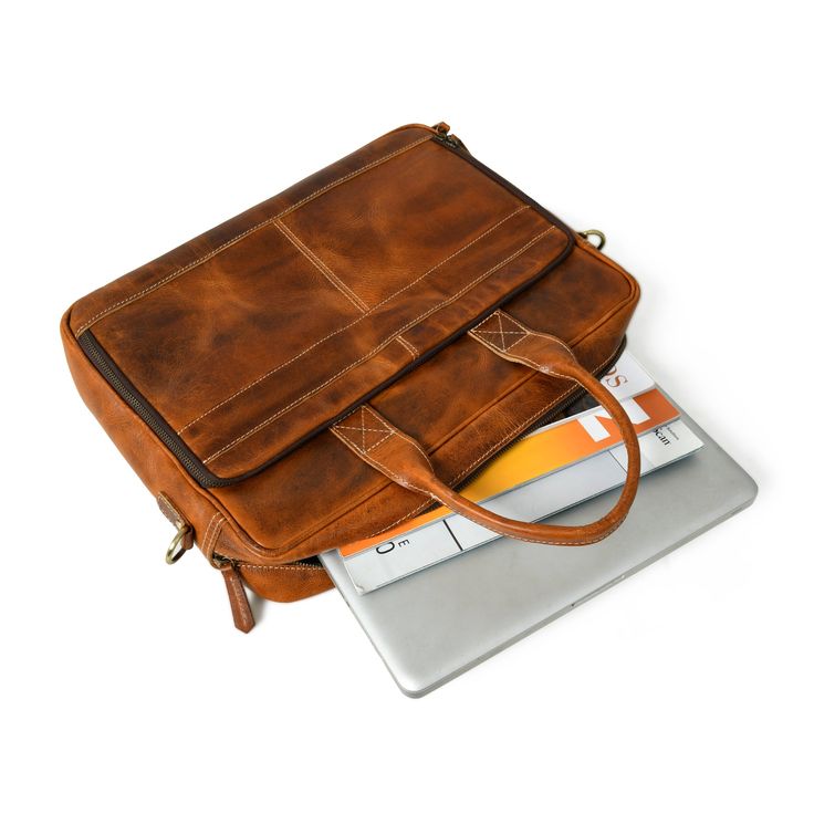 Elevate your professional presence with our Bison Elite Briefcase, meticulously crafted for a stylish edge. Fashioned from the finest full-grain buffalo leather, this masterpiece offers exceptional durability and a unique texture. Designed with capacious compartments and organizational elements, it seamlessly combines practicality with opulence. Its rich brown tone, complemented by striking orange accents, exudes undeniable sophistication, making it a perfect addition to any ensemble. Embrace th Professional Leather Rectangular Satchel, Professional Rectangular Leather Satchel, Leather Laptop Bag With Card Slots For Travel, Leather Laptop Bag With Interior Card Slots For Travel, Brown Leather Bag With Rectangular Case, Classic Leather Shoulder Bag In Rectangular Shape, Leather Briefcase With Leather Lining, Leather Satchel Laptop Bag With Interior Card Slots, Leather Rectangular Briefcase For Business Trips