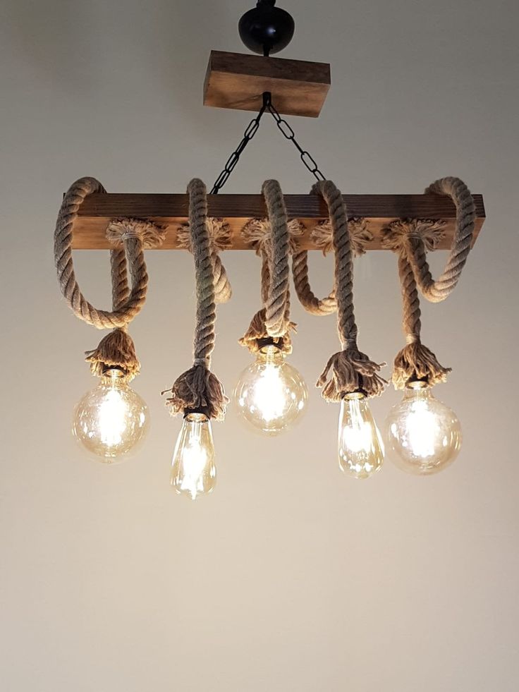 a light fixture with rope and bulbs hanging from the ceiling