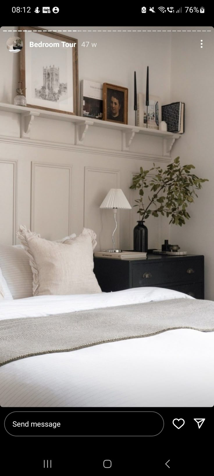 a bed room with a neatly made bed and some pictures on the wall above it