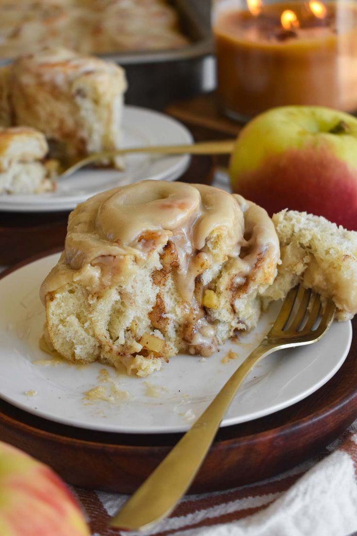 an apple cinnamon roll on a plate with a fork