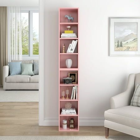 a living room with a white couch and pink book shelf