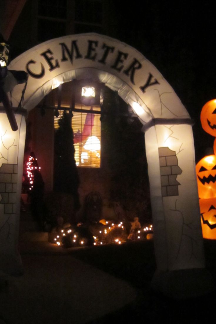 the entrance to cemetery decorated for halloween