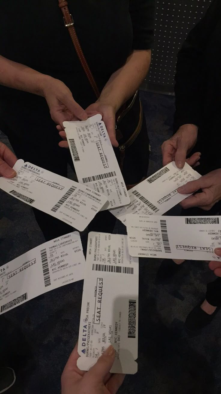 four people are holding their tickets in the shape of a star with barcodes on them