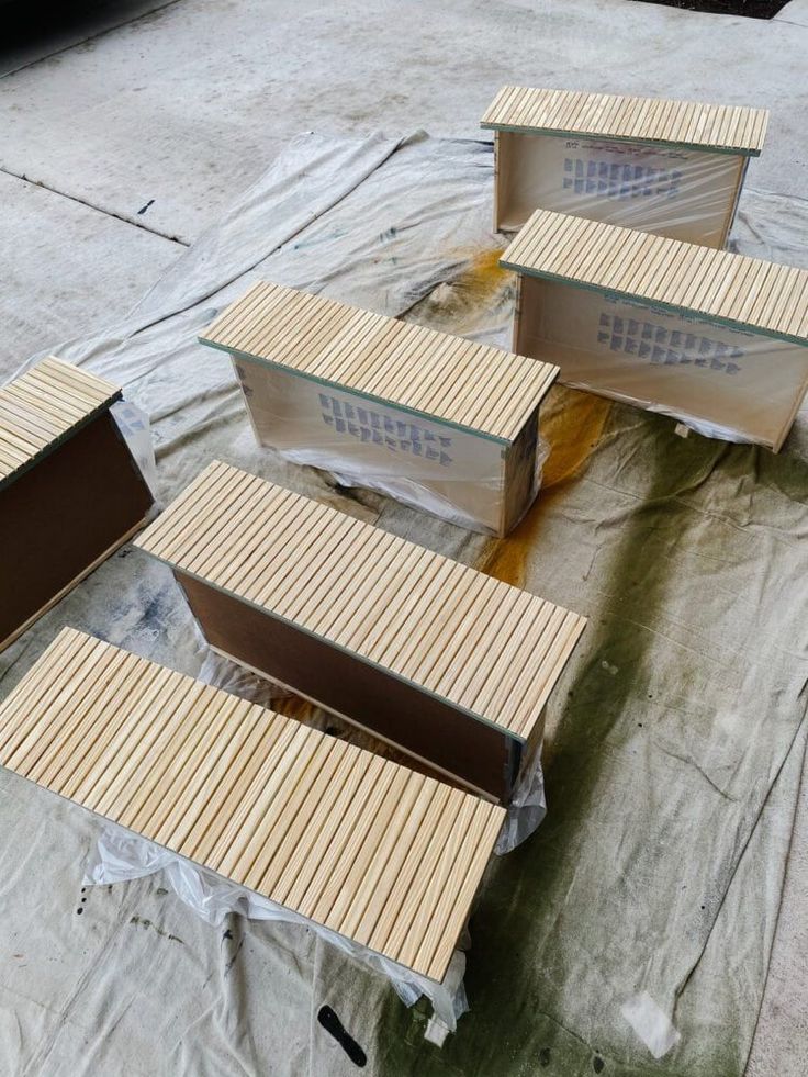 four boxes sitting on top of a tarp covered ground