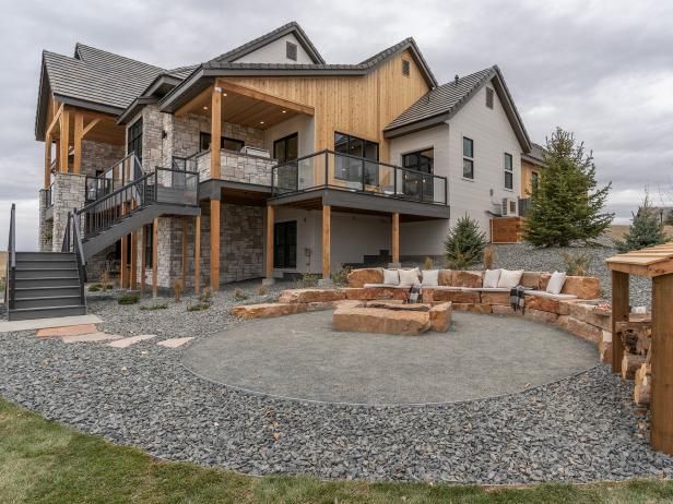 a large house with a fire pit in the front yard