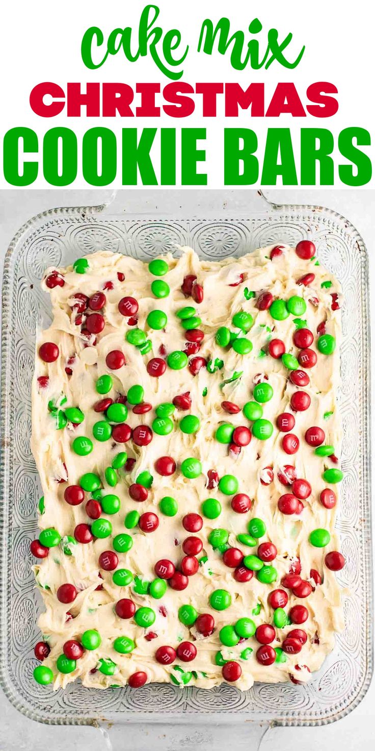 christmas cookie bars with white frosting and green candies on top in a glass baking dish