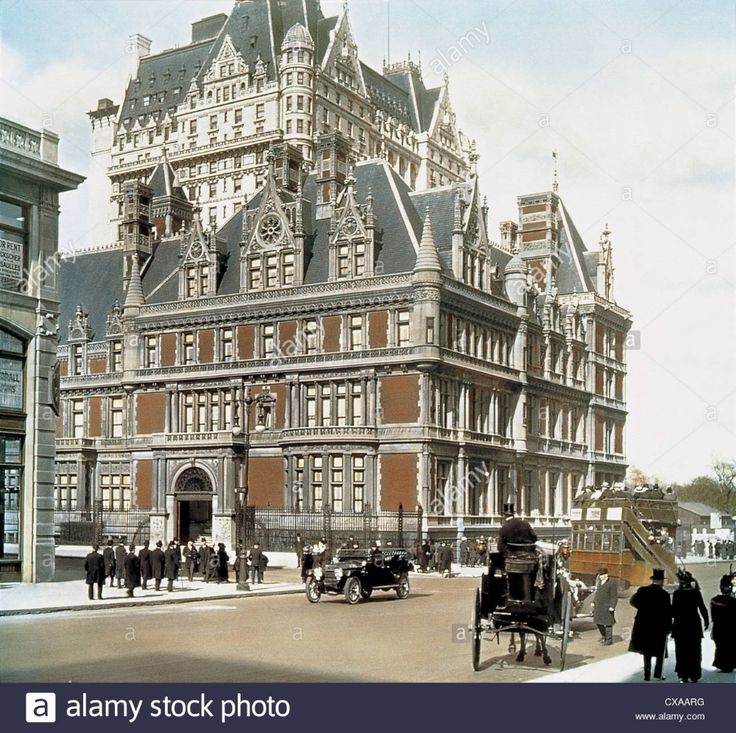 an old photo of people walking in front of a large building