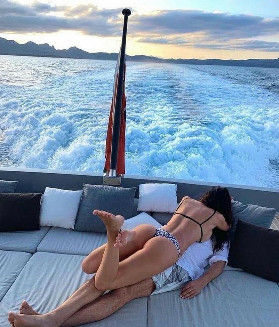 a woman laying on the back of a boat