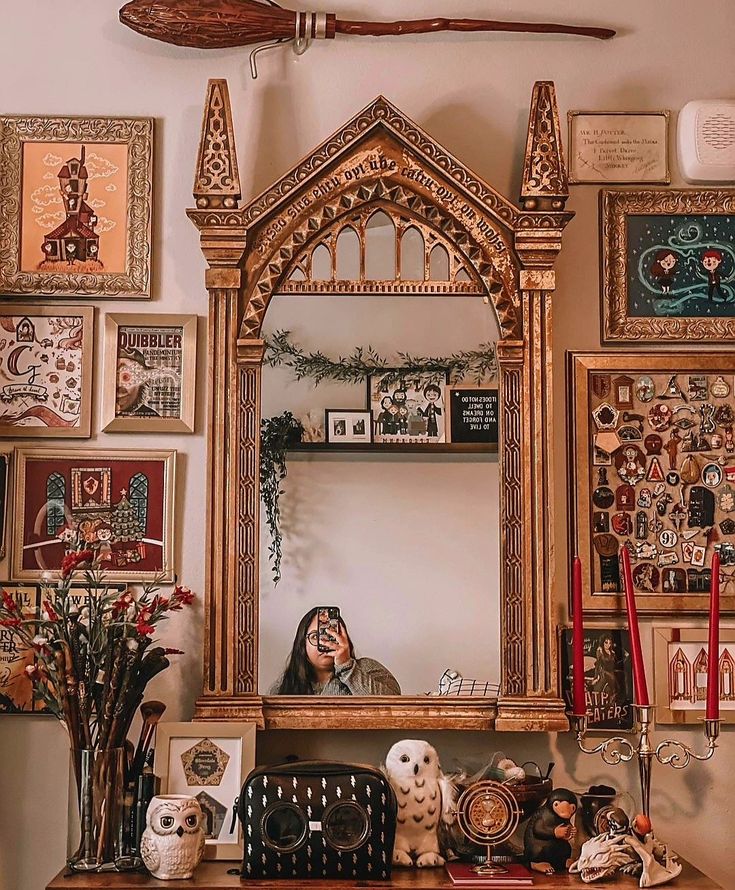 a mirror sitting on top of a wooden table next to pictures and other items in front of it