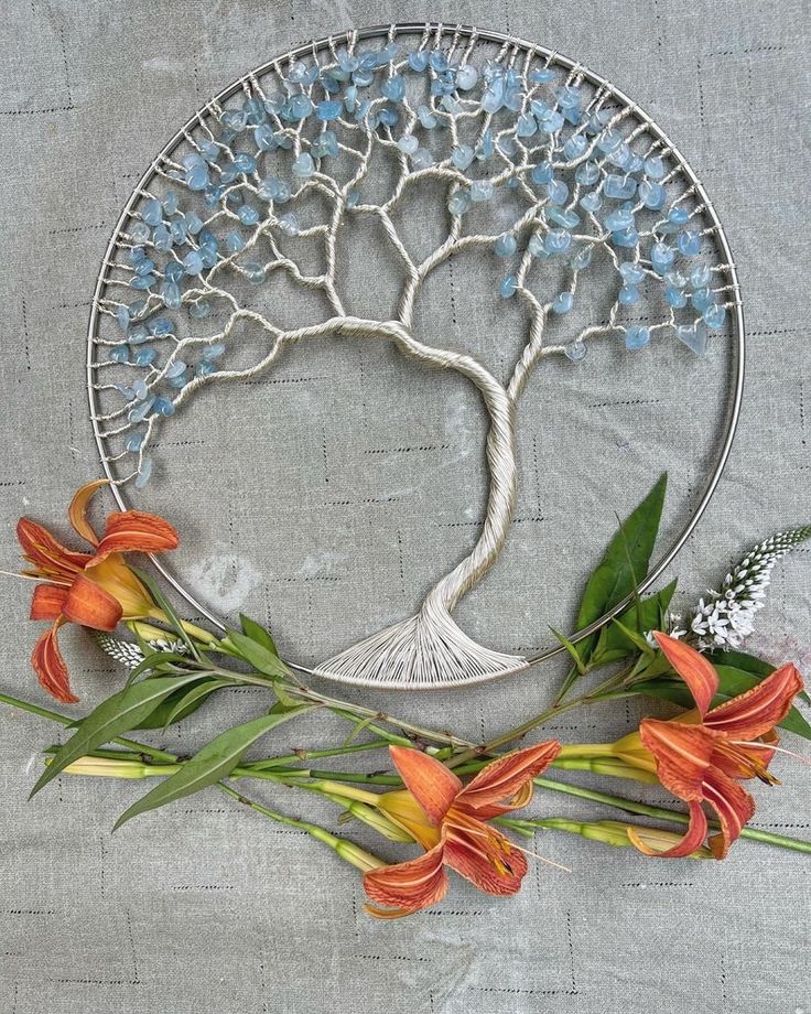 a metal plate with flowers and a tree on it