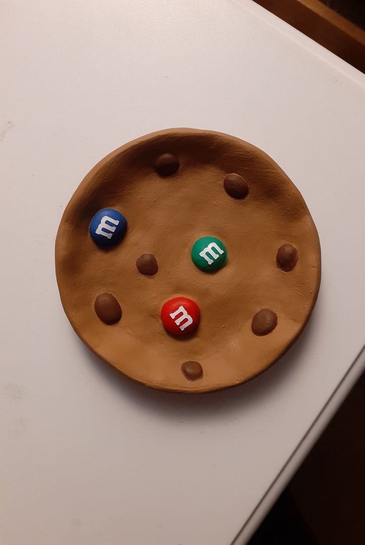 a cookie with four different colored buttons on it