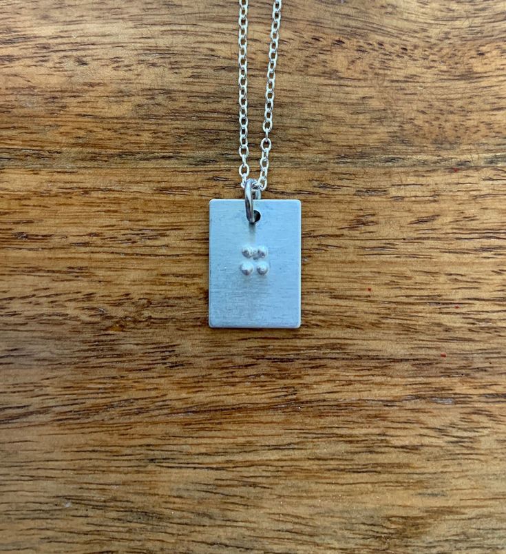 This is a Braille necklace in which you can fit 1-2 letters on. It's 18 inches and the pendant is 3/4 inch. It makes a great gift for friends, family, or yourself, especially with the holidays coming up! Braille Necklace, 2 Letter, Name Necklaces, Name Necklace, For Friends, Dog Tag Necklace, Necklace Lengths, Gifts For Friends, 4 Inch