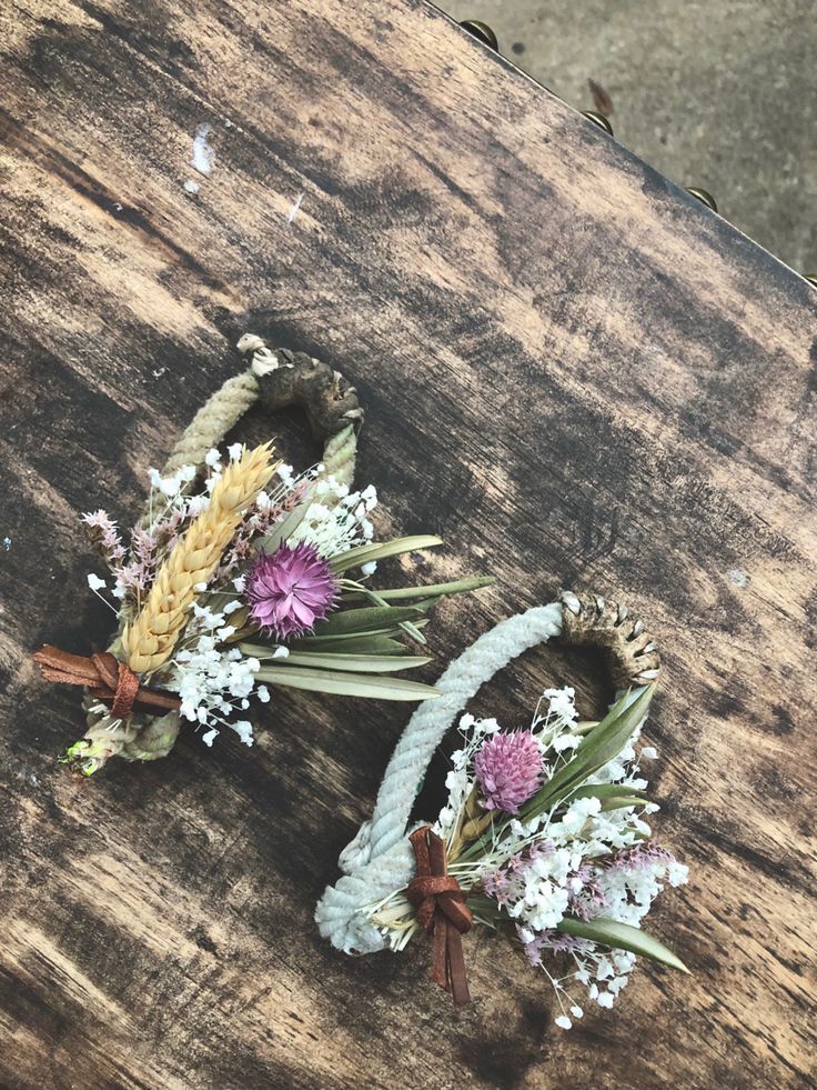 some flowers are laying on top of a wooden table and it looks like they have been made out of wood