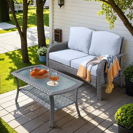 a couch and coffee table on a patio