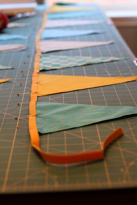 a table topped with lots of different types of fabric on top of a cutting board