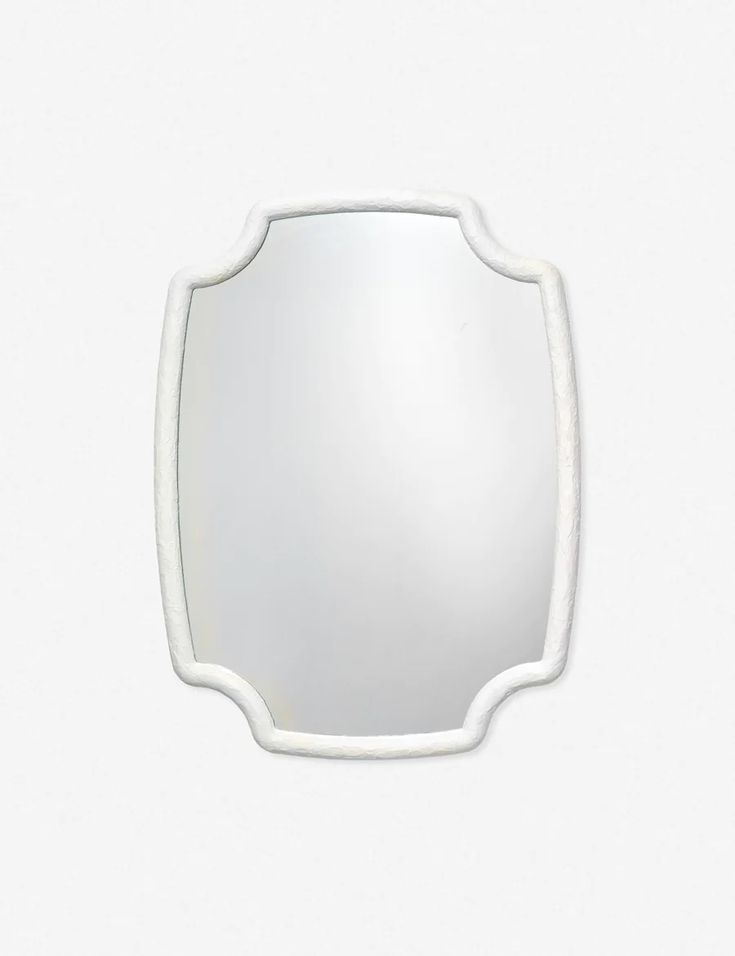 an oval mirror with white trim around the edges on a white wall mounted fixture, viewed from above