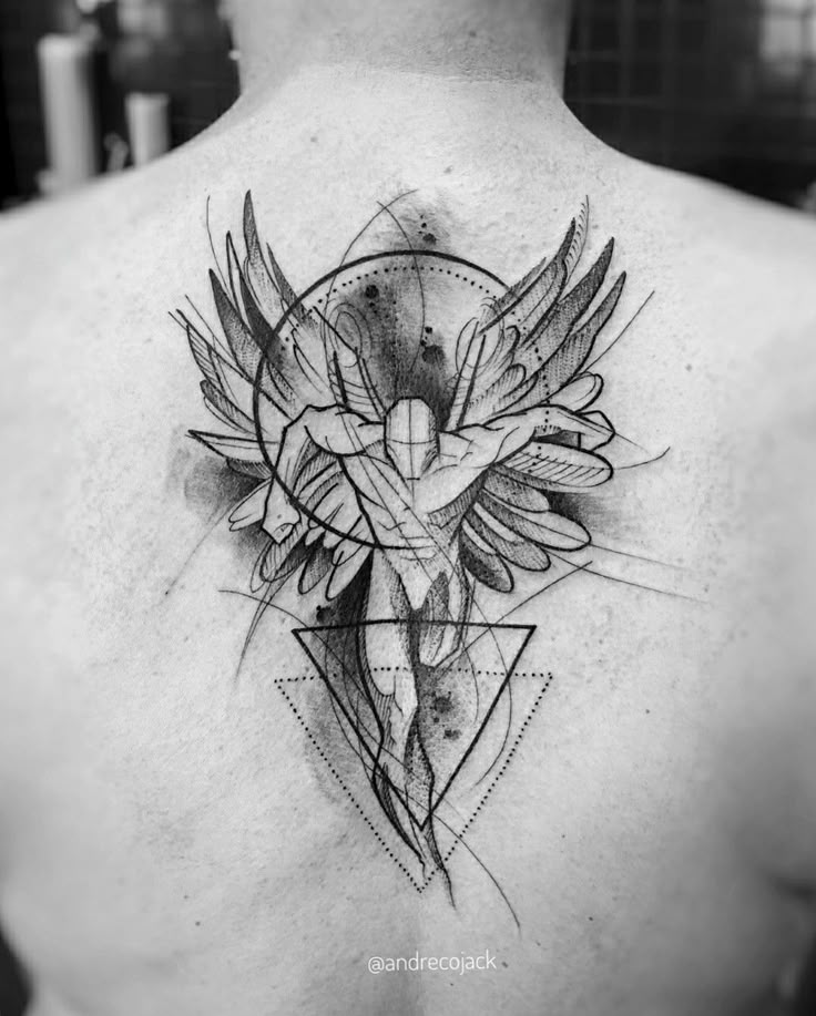 the back of a man's neck with a cross and wings tattoo on it