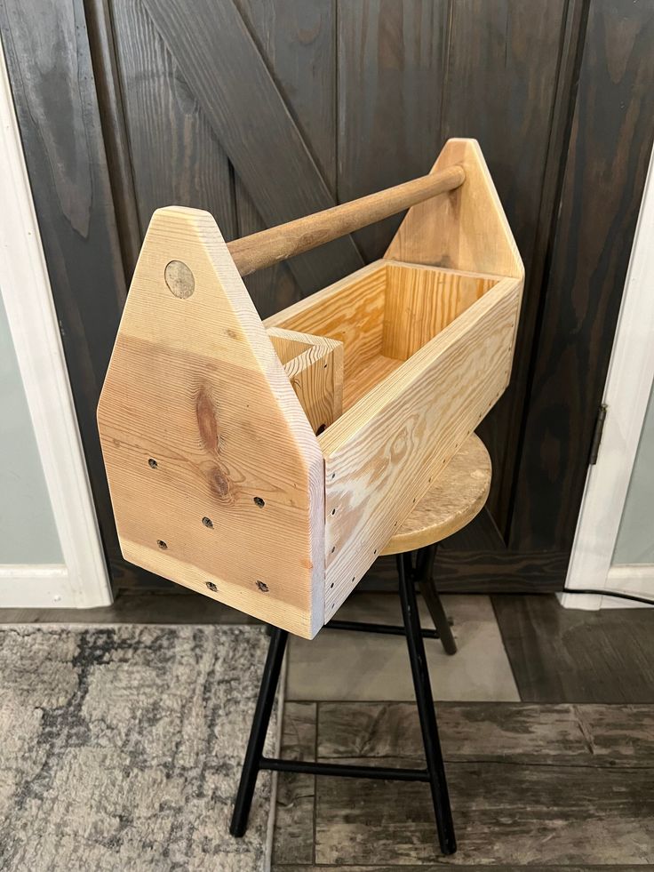 a wooden box sitting on top of a stool