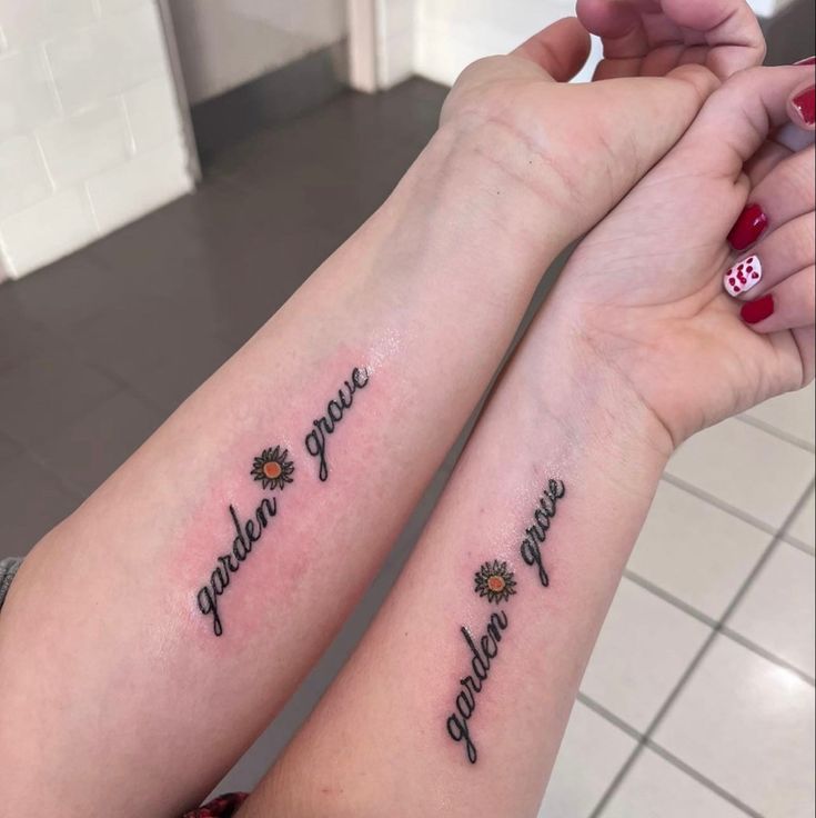 two girls with matching tattoos on their arms that say, together we are sunshineflowers