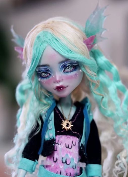 a close up of a doll with blue hair and makeup