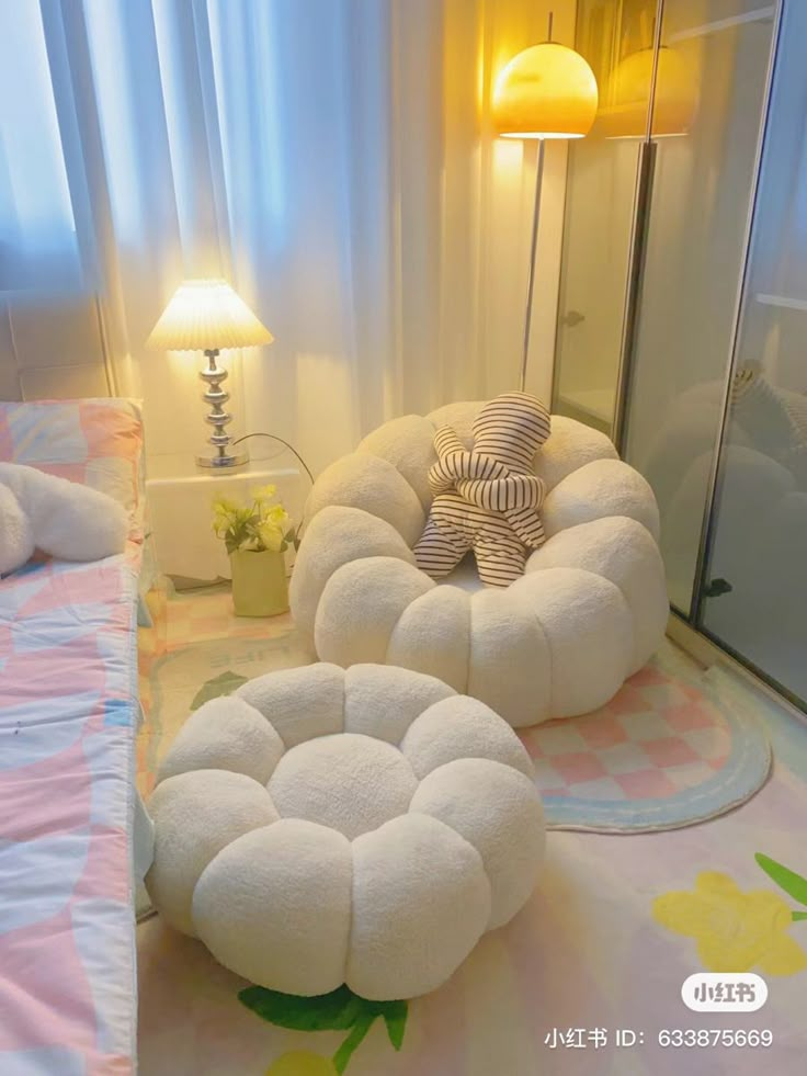 a bed room with two beds and a teddy bear sitting on the floor next to each other