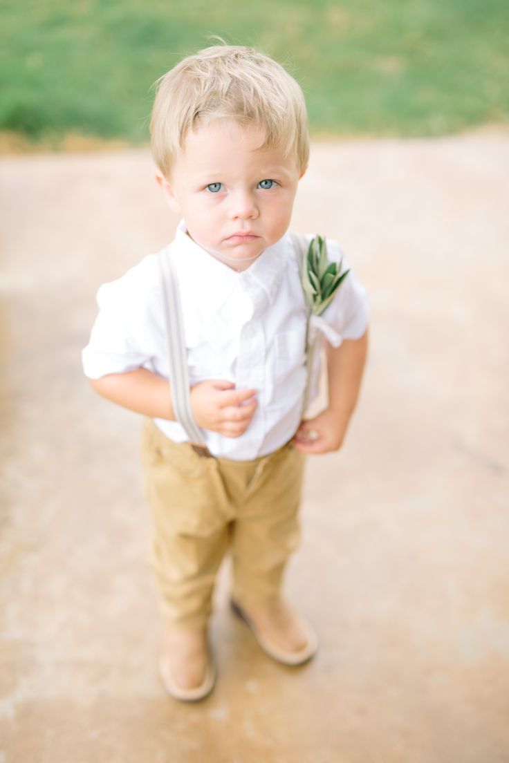 a little boy that is standing up with some scissors in his hand and looking at the camera