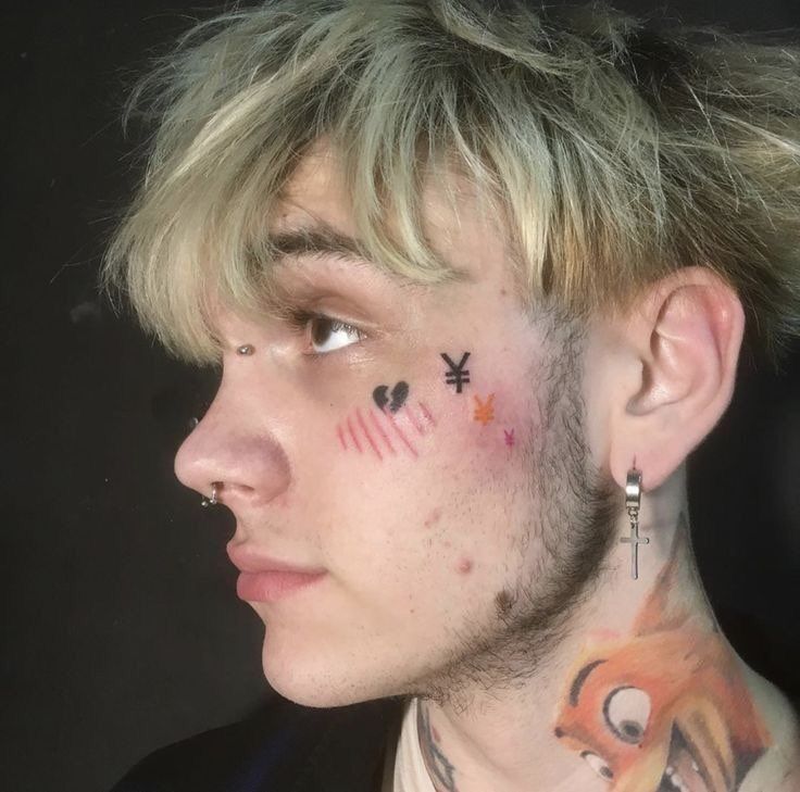 a man with tattoos on his face and neck