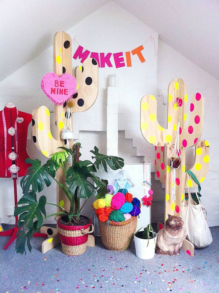 some fake cactuses are on display in a room with polka dots and other decorations