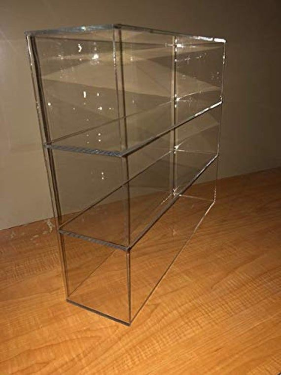 a glass display case sitting on top of a wooden floor