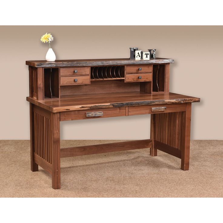 a wooden desk with drawers and a vase on top