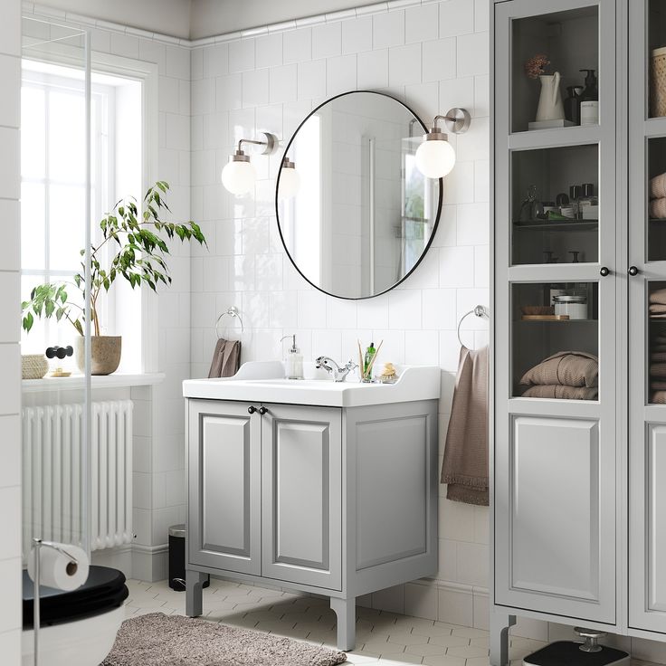 a bathroom with a sink, mirror and shelving unit