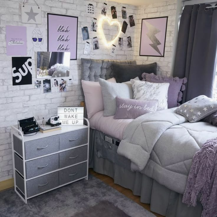 a bed room with a neatly made bed and lots of pictures on the wall above it