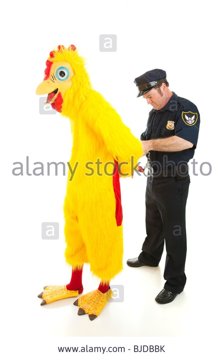 a police officer is standing next to a chicken mascot that has his hand on the leg