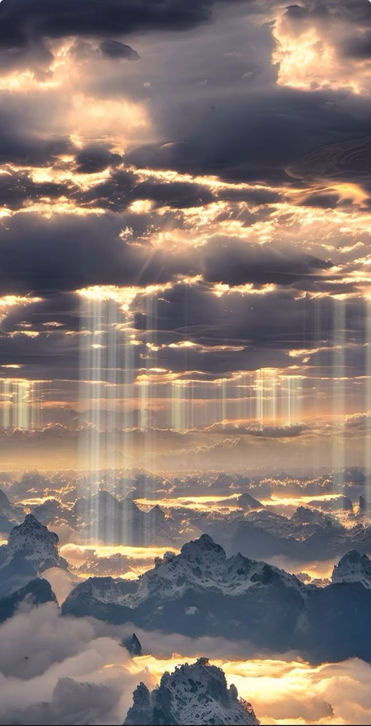 the sky is filled with clouds and light beams that are shining in the distance over mountains