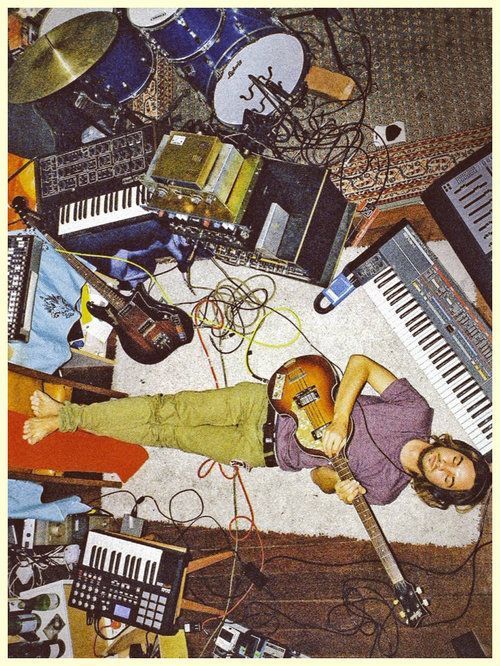 a woman laying on the floor surrounded by musical instruments