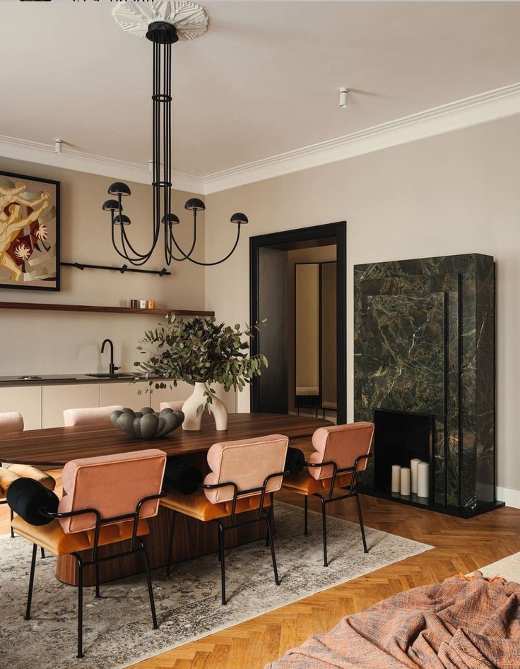 a dining room table with six chairs and a chandelier hanging from the ceiling