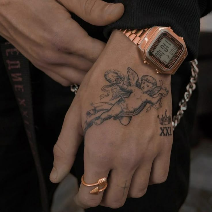 a person with a tattoo on their arm and wrist holding onto a watch that is attached to the wrist