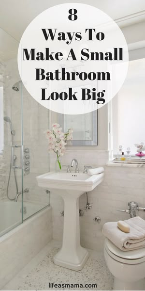 a white bathroom with a toilet, sink and shower