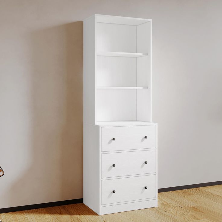 a tall white bookcase next to a wall