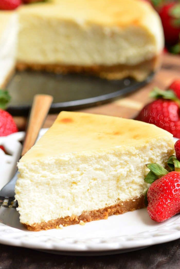 a slice of cheesecake on a plate with strawberries