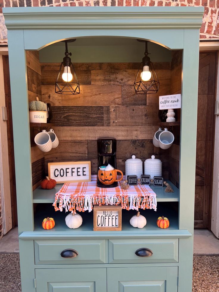 a coffee bar with pumpkins and signs on it