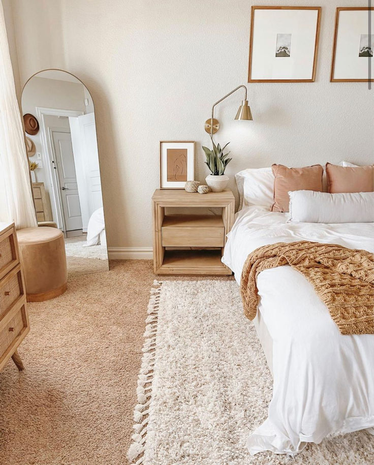 a bedroom with a bed, dresser and mirror on the wall next to each other