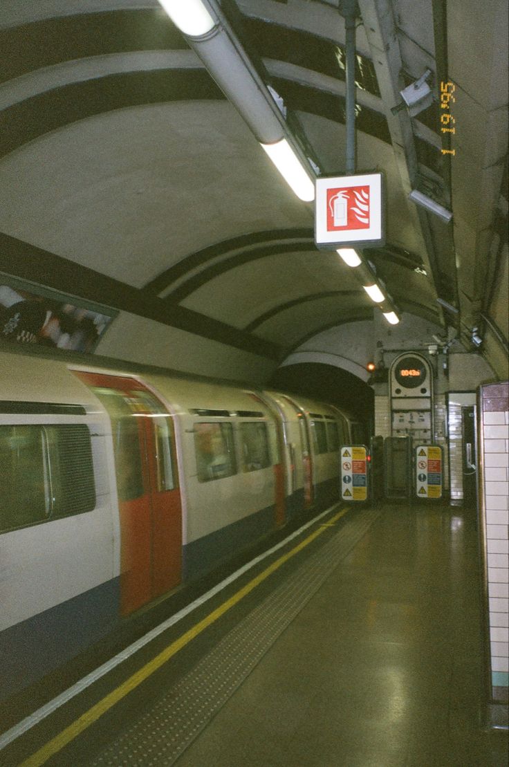 a subway station with a train pulling into it