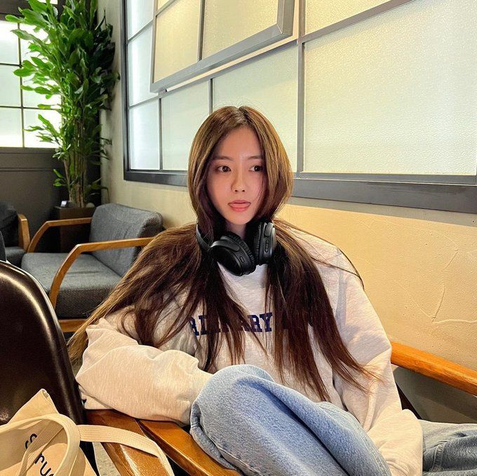 a woman sitting at a table with headphones on